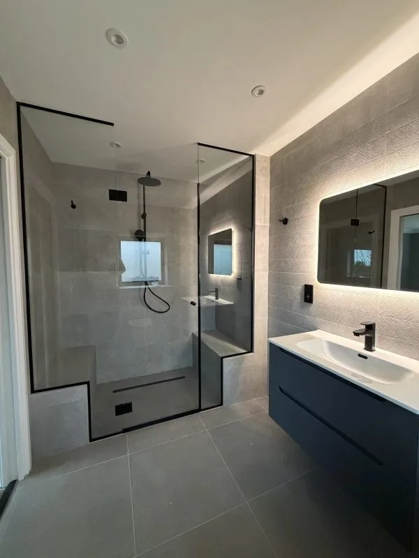 Shower enclosure with black feature hardware in Cambridgeshire home