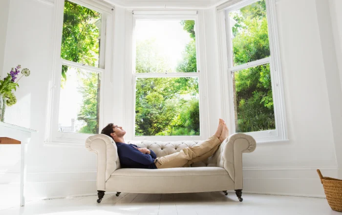 Man in front of window fitted with Fineo Vacuum Glazing